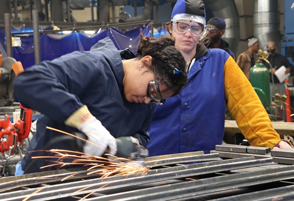 Woman Grinding Metal