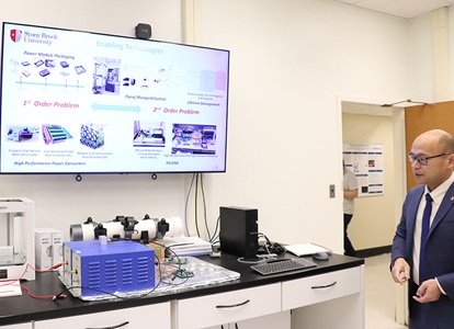 Fang Luo Demonstrating Equipment the in Spellman High Voltage Laboratory