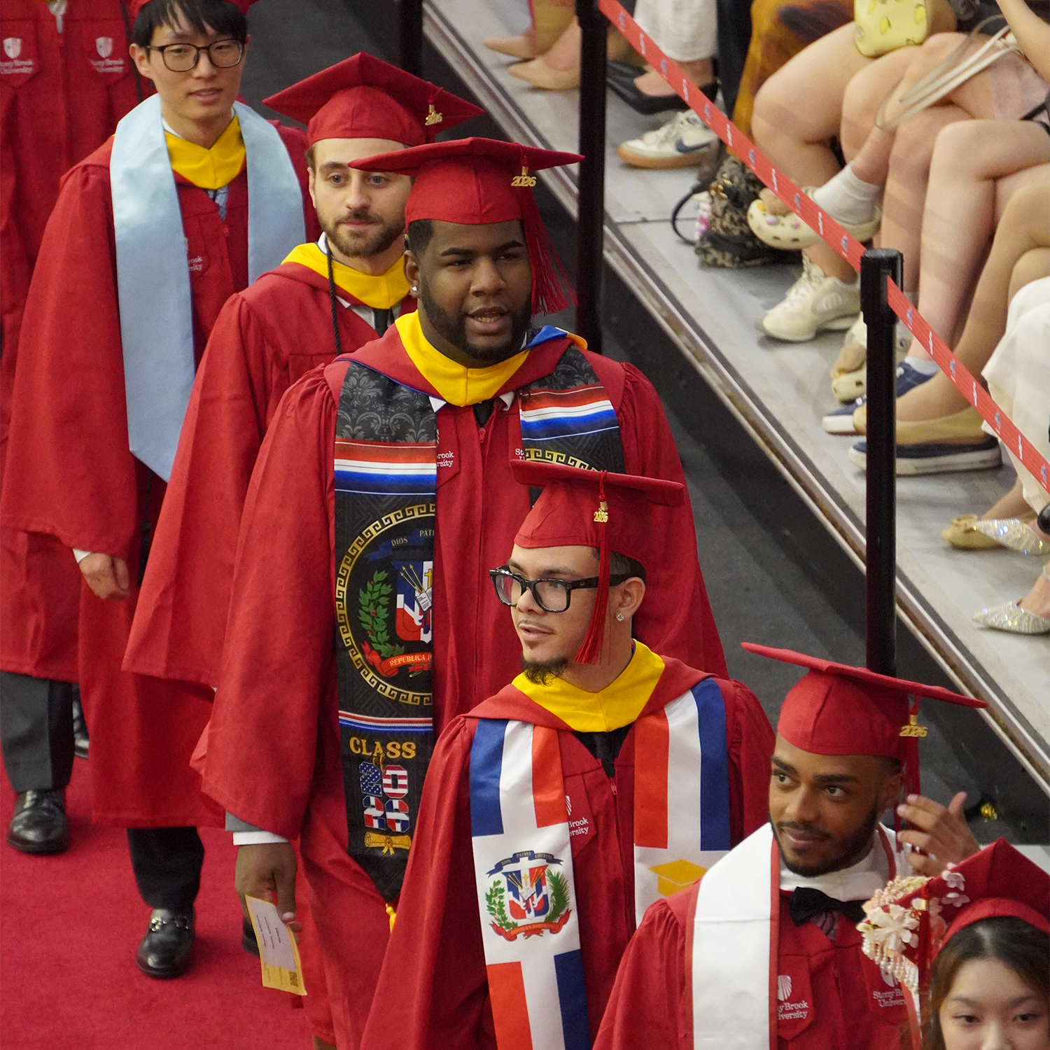 college of business graduates walking into ceremony