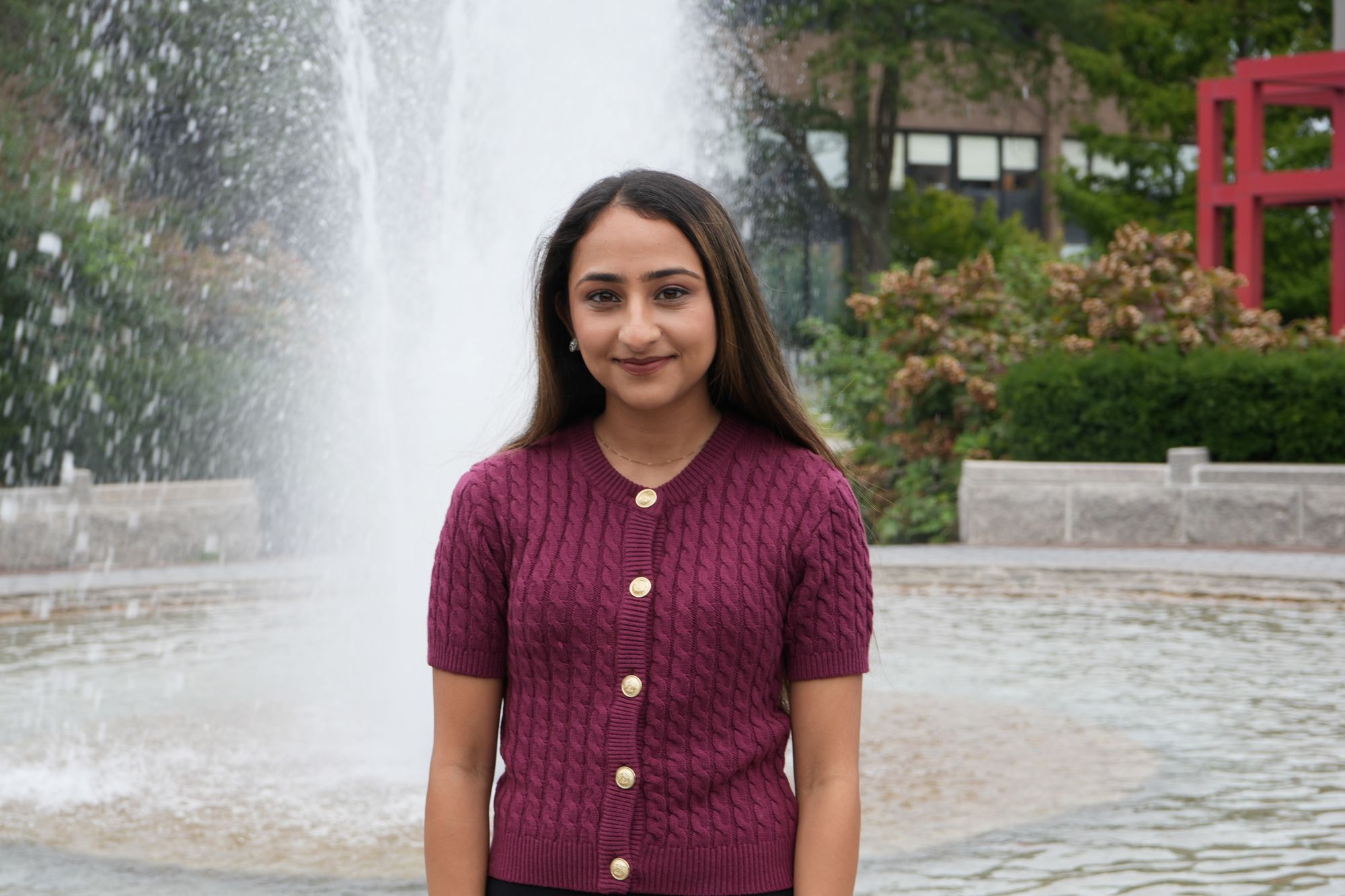 Person standing in front of a fountain outdoors