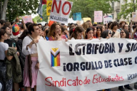 Group of people holding a banner at a pride event.