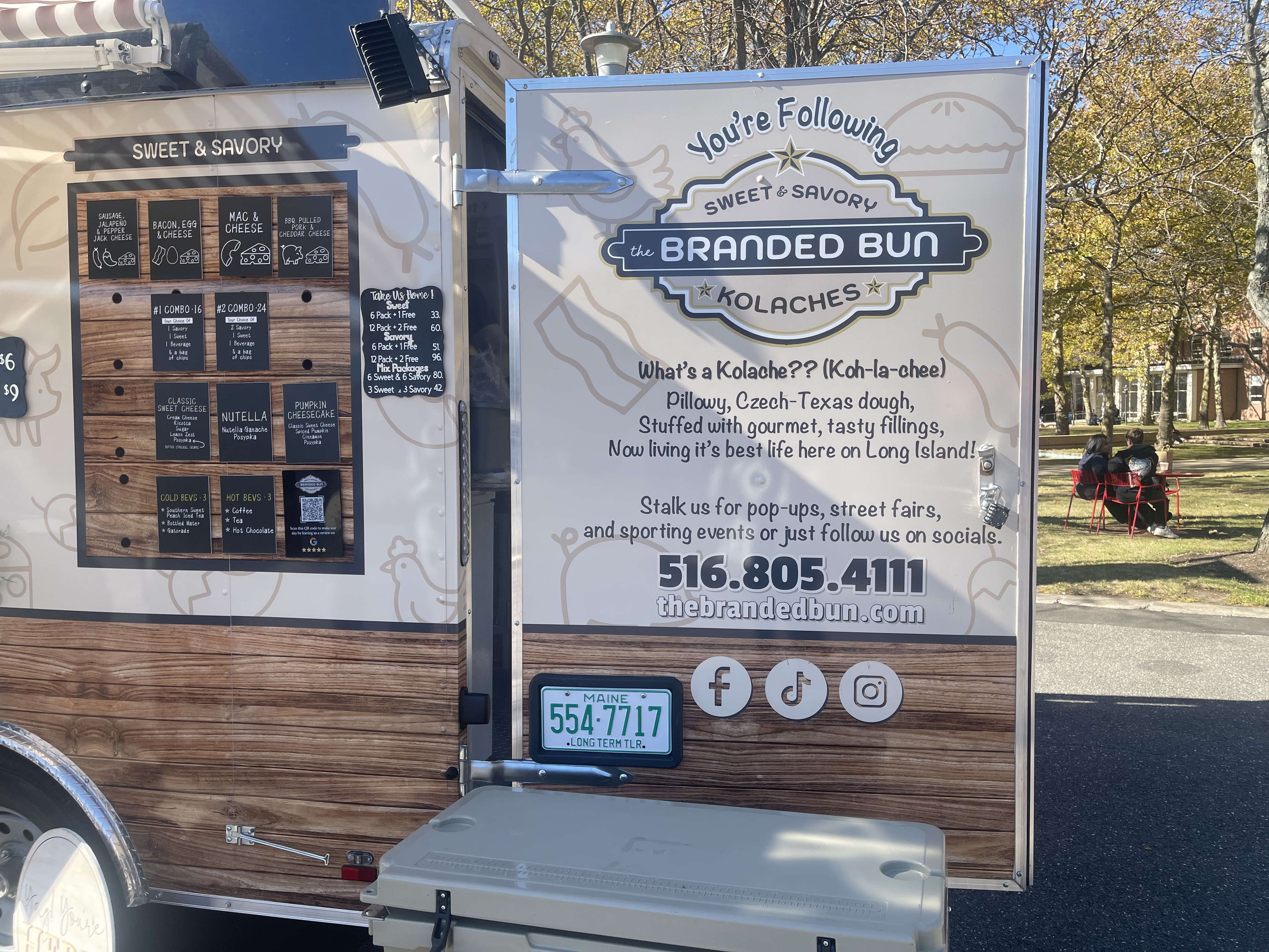 Picture of the truck's branded side panel folded out, also featuring their menu